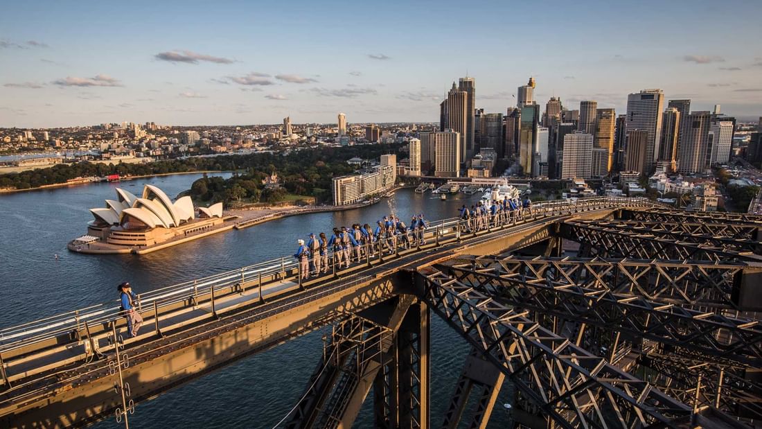 People climbing the Sydney Harbour Bridge with Opera House view, near Novotel Sydney on Darling Harbour