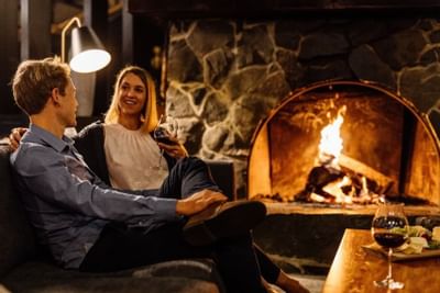 A couple having vine in Hazards Bar & Lounge at Freycinet Lodge