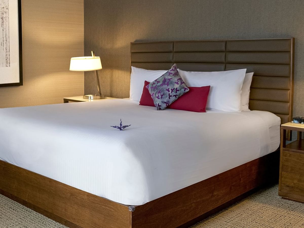 Bed, night stands, and lamps in a hotel room