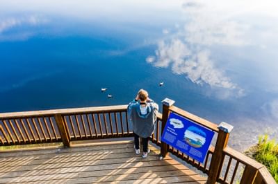 view of a lake and woman in the terrace near Wedgewood Resort