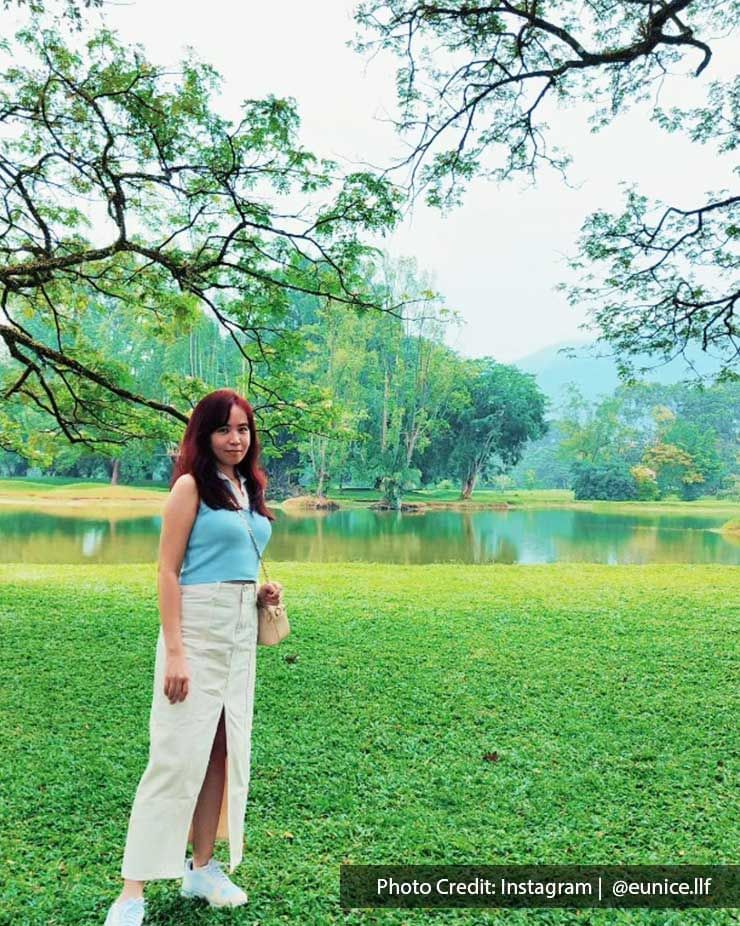 A lady was taking a picture at the Taiping Lake Gardens - Lexis Suites Penang