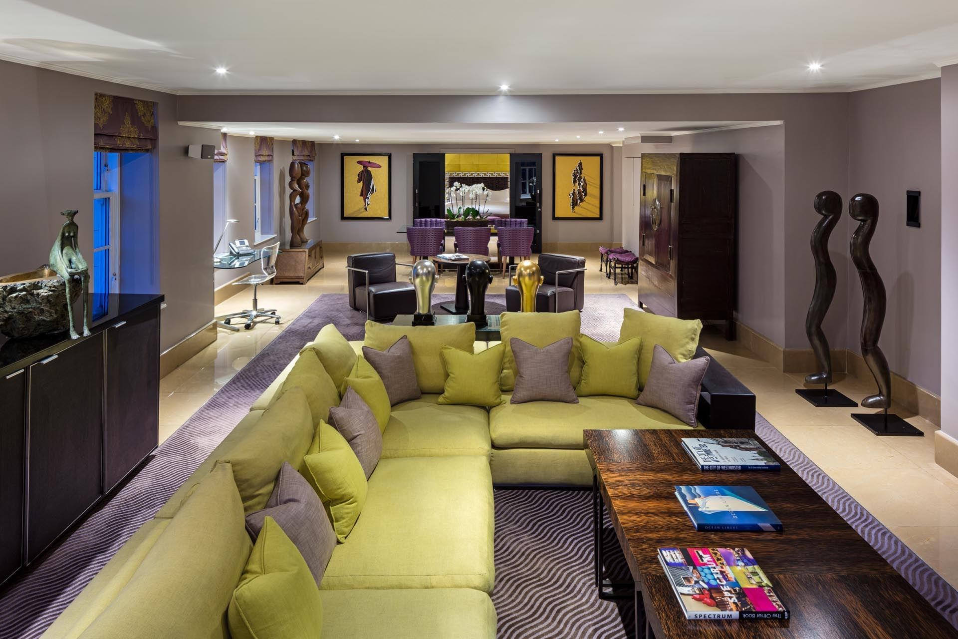 Amarillo Suite lounge area featuring a large green sofa and modern decor at The May Fair Hotel