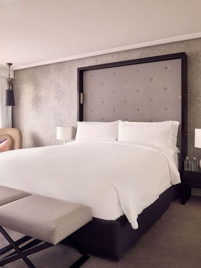Ottoman and lounge chair by the bed in Signature Suite at Sofitel Brisbane Central