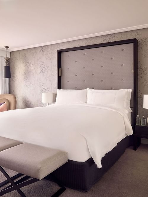 Ottoman and lounge chair by the bed in Signature Suite at Sofitel Brisbane Central