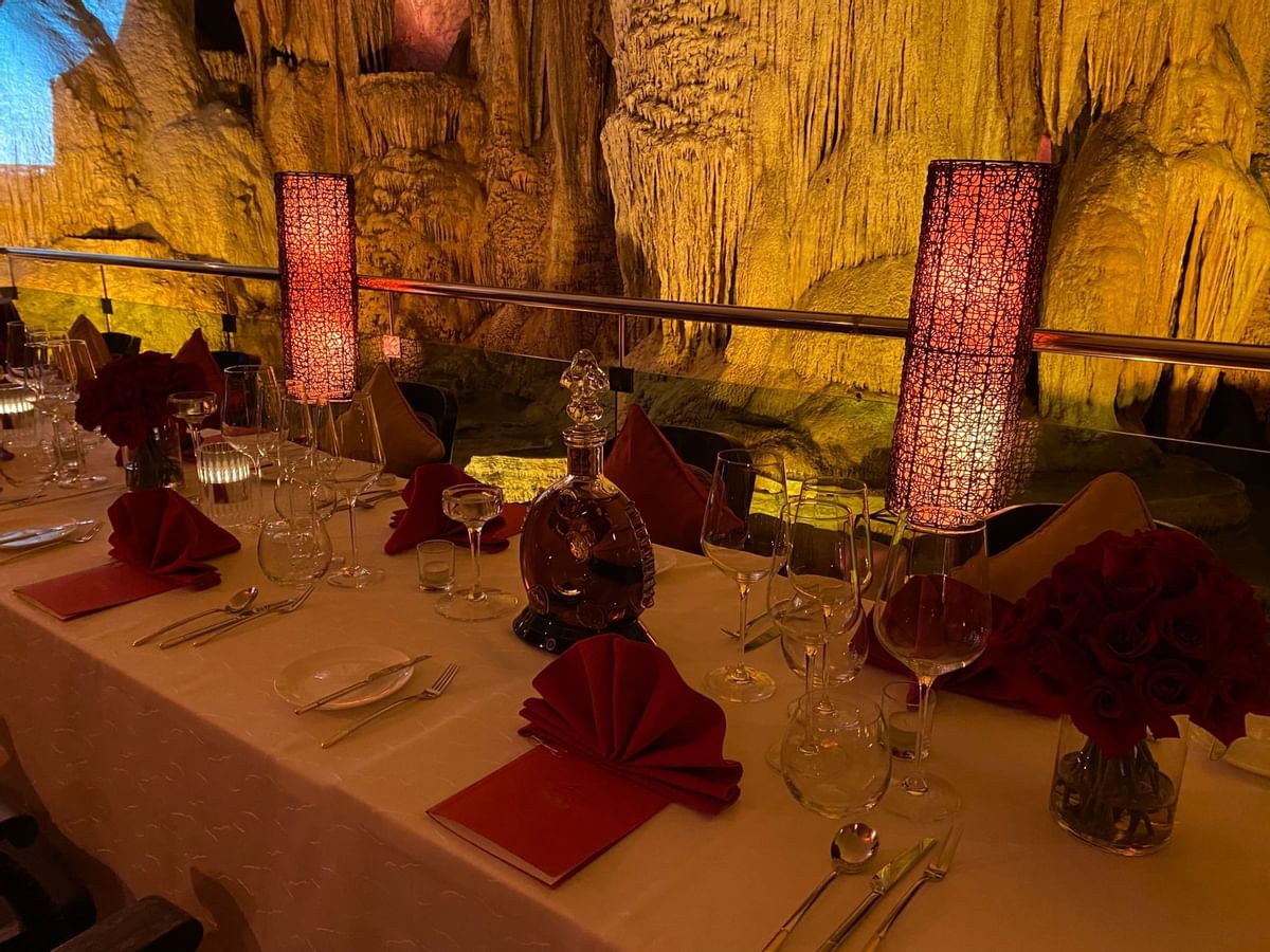 Close-up of roses & liquor beverages on a table served at The Banjaran Hotsprings Retreat
