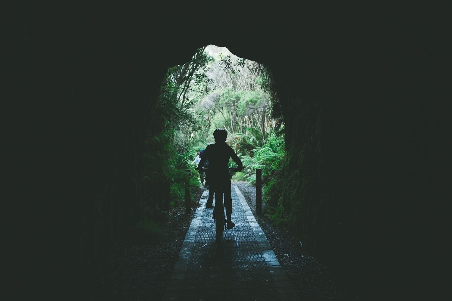 Children exploring the Spray Tunnel near Strahan Village