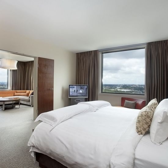 King bed & lounge in a Room at Pullman Sydney Olympic park