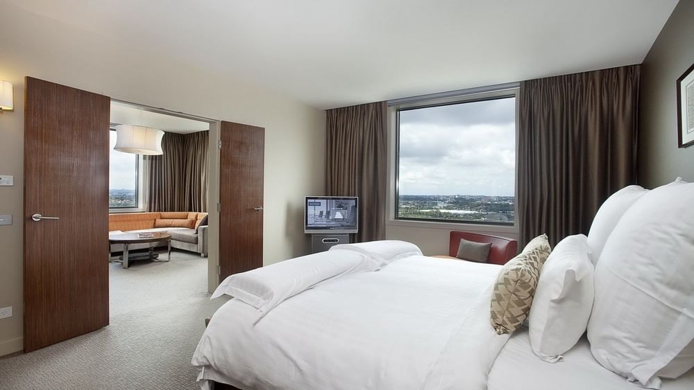 King bed & lounge in a Room at Pullman Sydney Olympic park