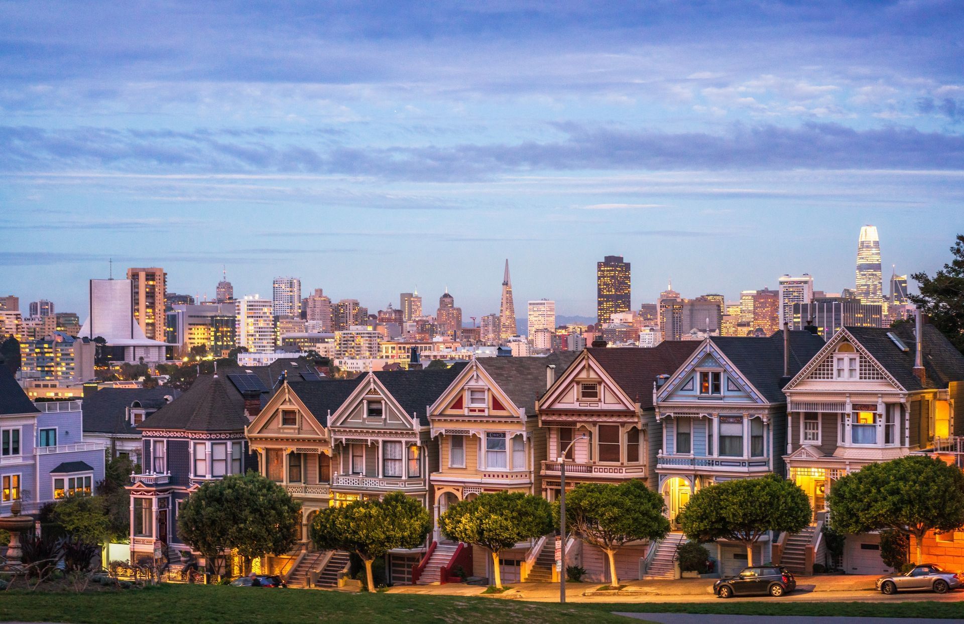 a row of houses with a city skyline in the background