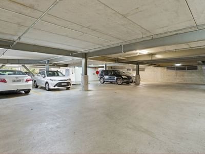Several cars parked in an underground parking area at Student Living Auckland Anzac.