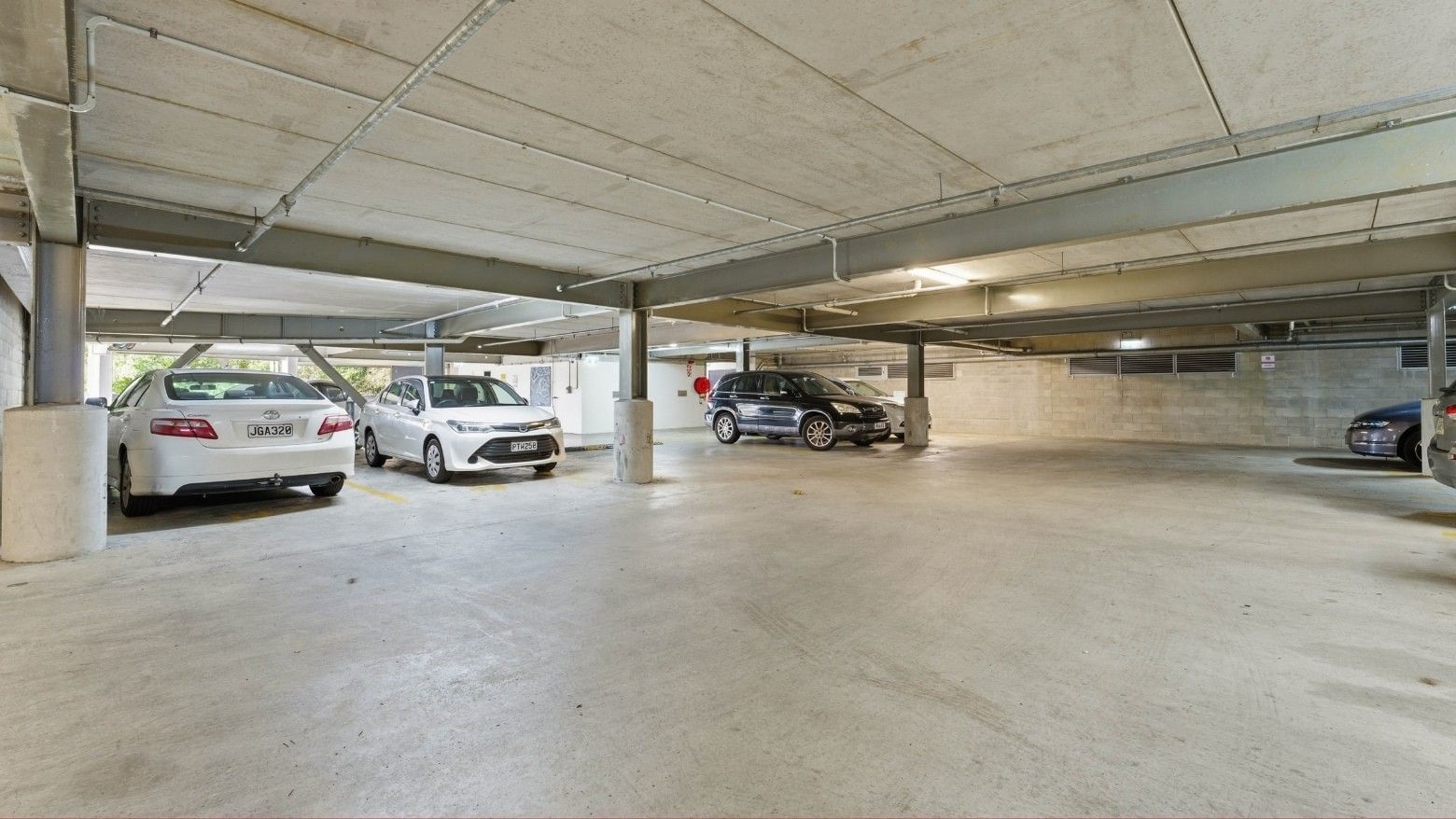 Several cars parked in an underground parking area at Student Living Auckland Anzac.