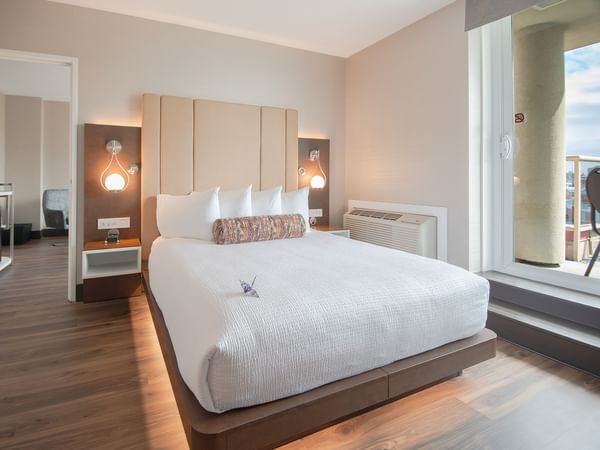 A spacious hotel junior suite with queen bed at Coast Victoria Hotel & Marina by APA