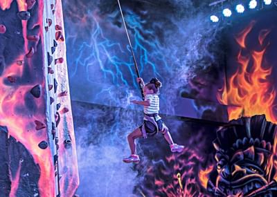 Young guest navigating the indoor ropes course adventure in Paradise Pier at Margaritaville Resort Biloxi