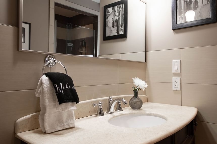 Bathroom vanity with mirror & towels in King Superior Den at Retro Suites Hotel