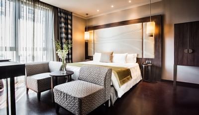 Bed & furniture in Deluxe Room at Uptown Palace