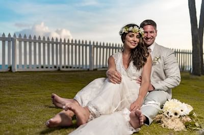 A wedding couple posing in the garden at Bougainvillea Barbados