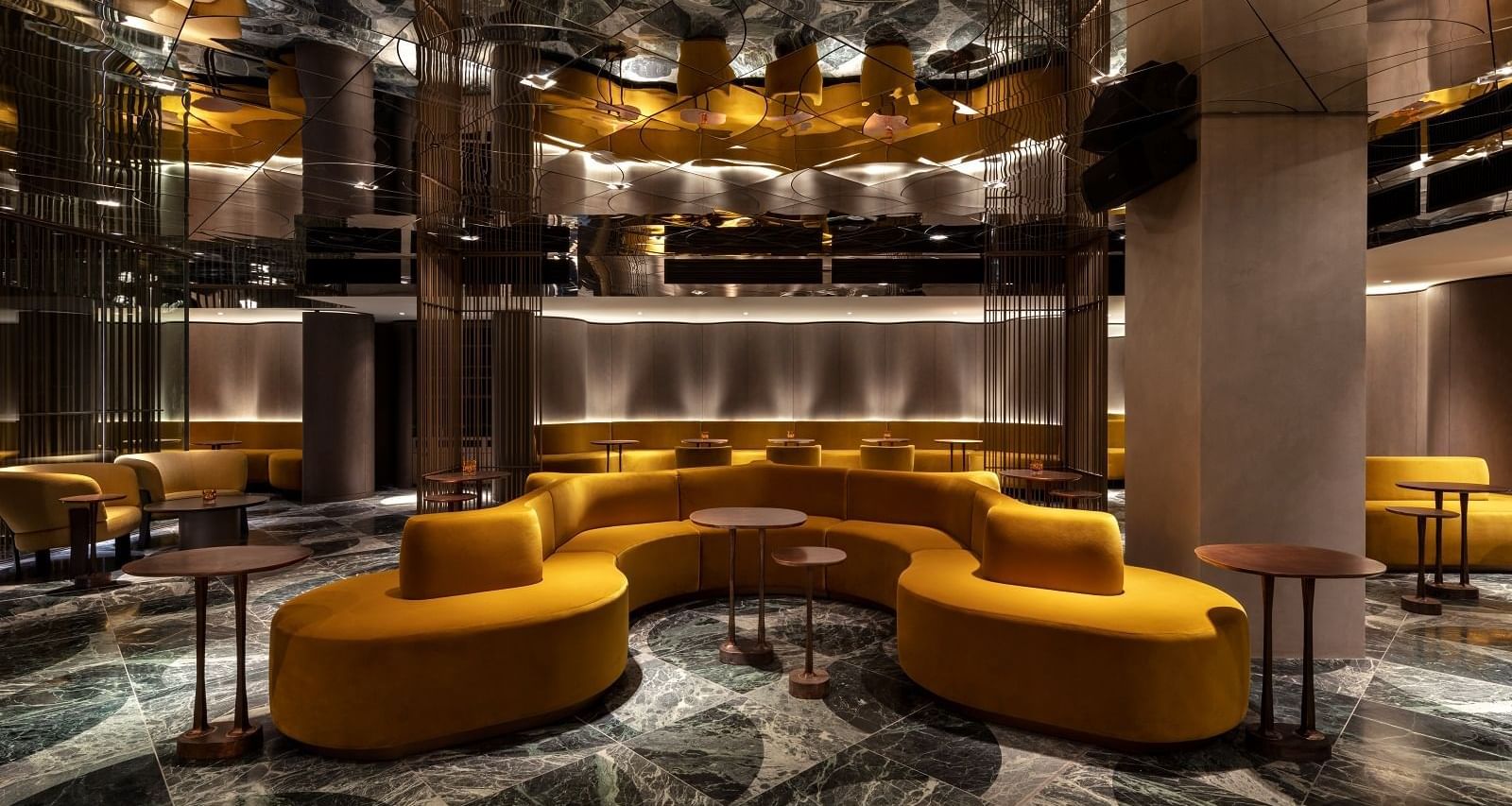 The Green Room interior with golden accents and plush seating at The Londoner Hotel