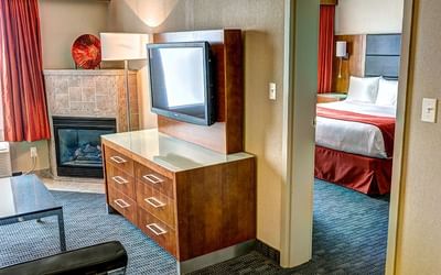 TV arranged in the living area in Bedroom at Fort McMurray Hotel