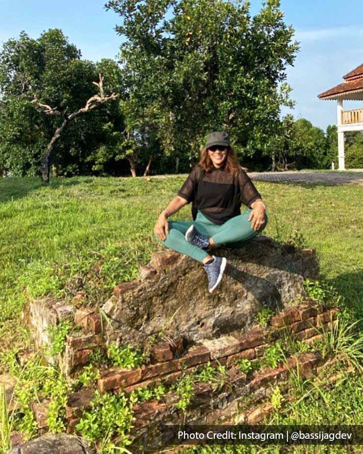 a woman sitting on a rock