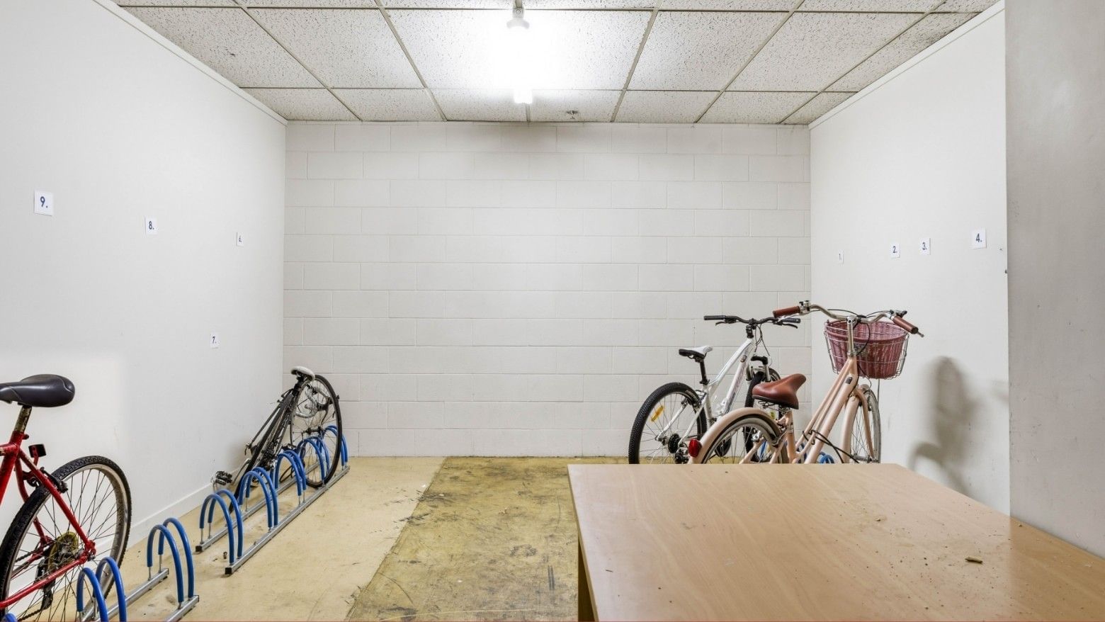 Four bicycles in a small room with a table at UniLodge Stafford House.