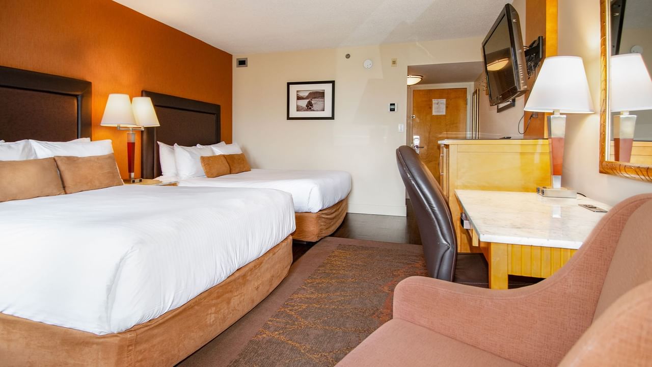 Hotel guest room with two queen beds and a balcony