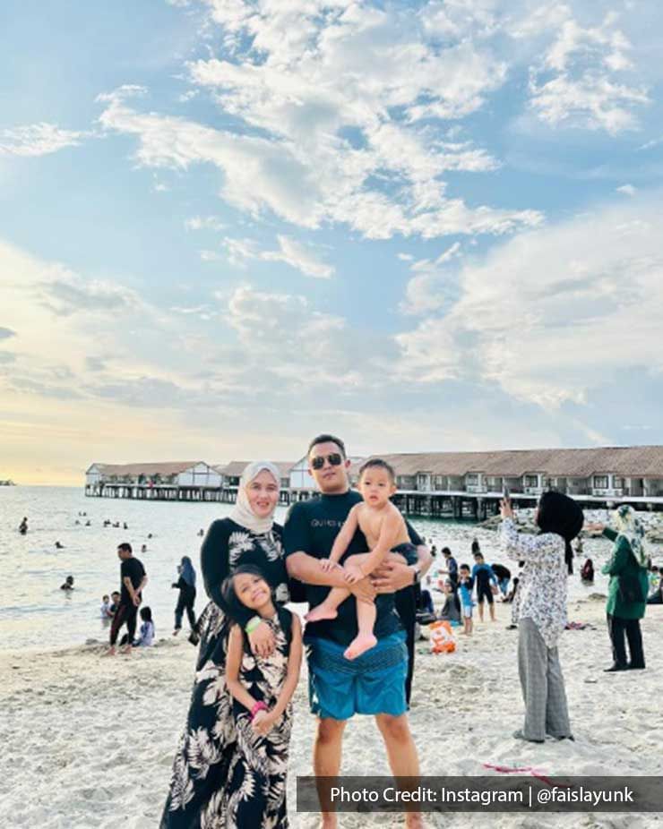 a family taking a picture on the beach 