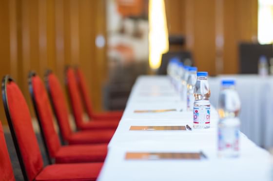 Table of the room conference prepared with folders,pen and water