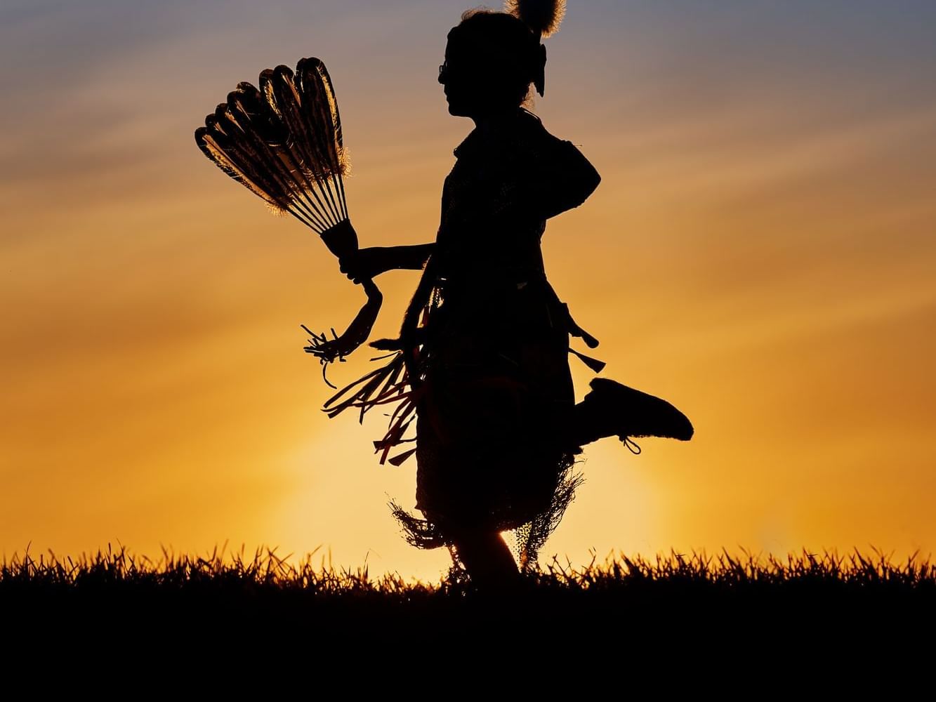 Silhouette of Native American dancer featuring Northern Spirit near Merit Hotel & Suites