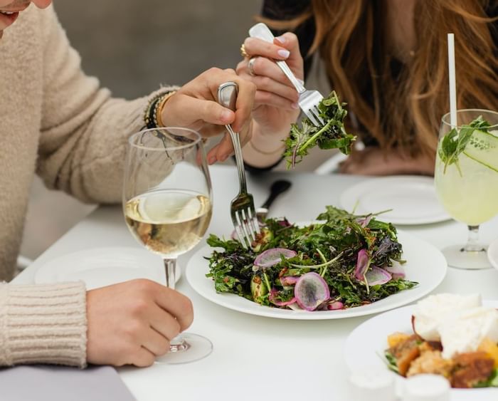 A couple dining in the restaurant at Luxe Sunset Boulevard Hotel