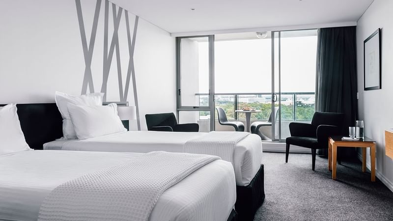Interior of Studio Room with 2 Single Beds with a balcony at Quay West Suites Melbourne