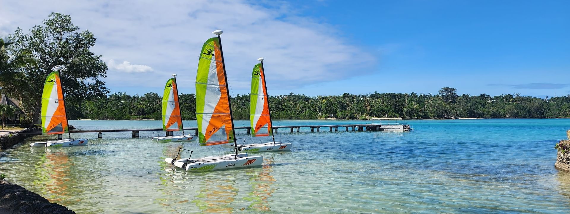 Four sailboards floating near the shore at Warwick Le Lagon - Vanuatu in Efate