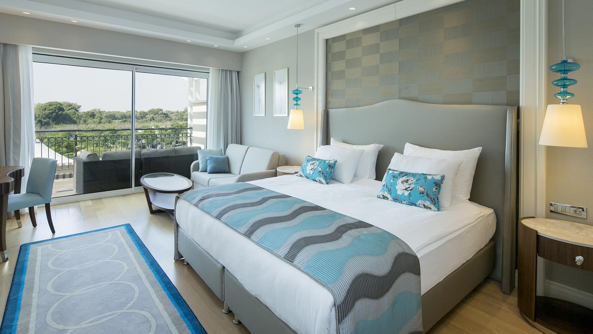 Titanic Deluxe Golf Belek'teki Family Pool Suite Balcony'de yatak yanındaki oturma alanı.