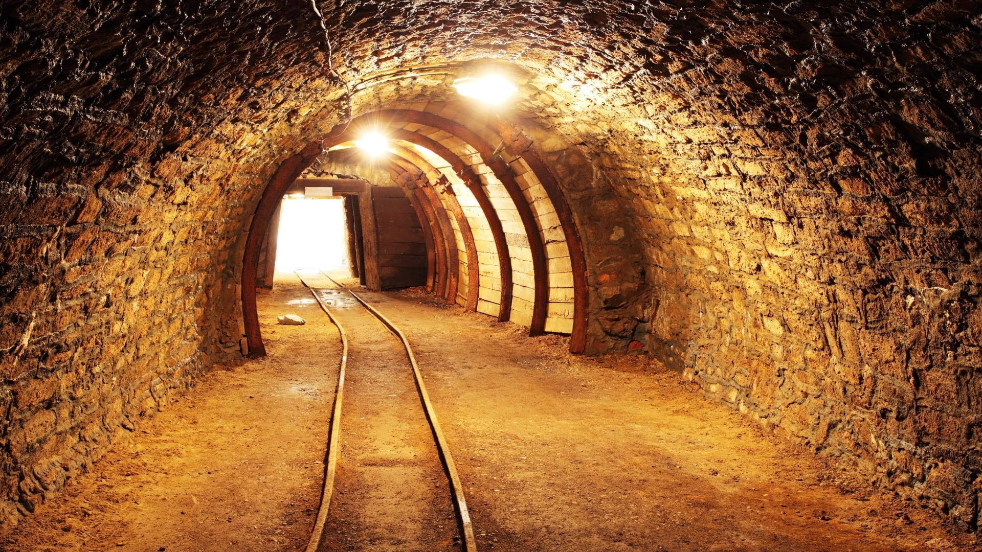 Mina del eden Old underground mine tunnel with stone walls, wooden supports, and dim lights near Quinta Real Zacatecas