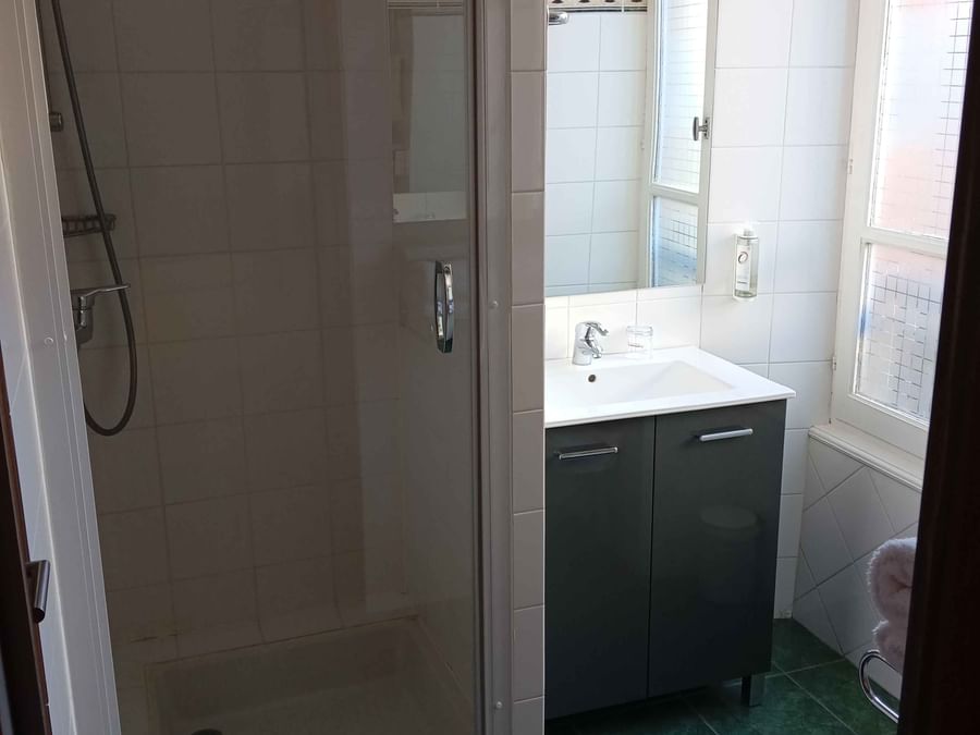 Bathroom with glass shower and vanity in Double Comfort at The Originals Boutique Grand Hôtel Saint-Pierre