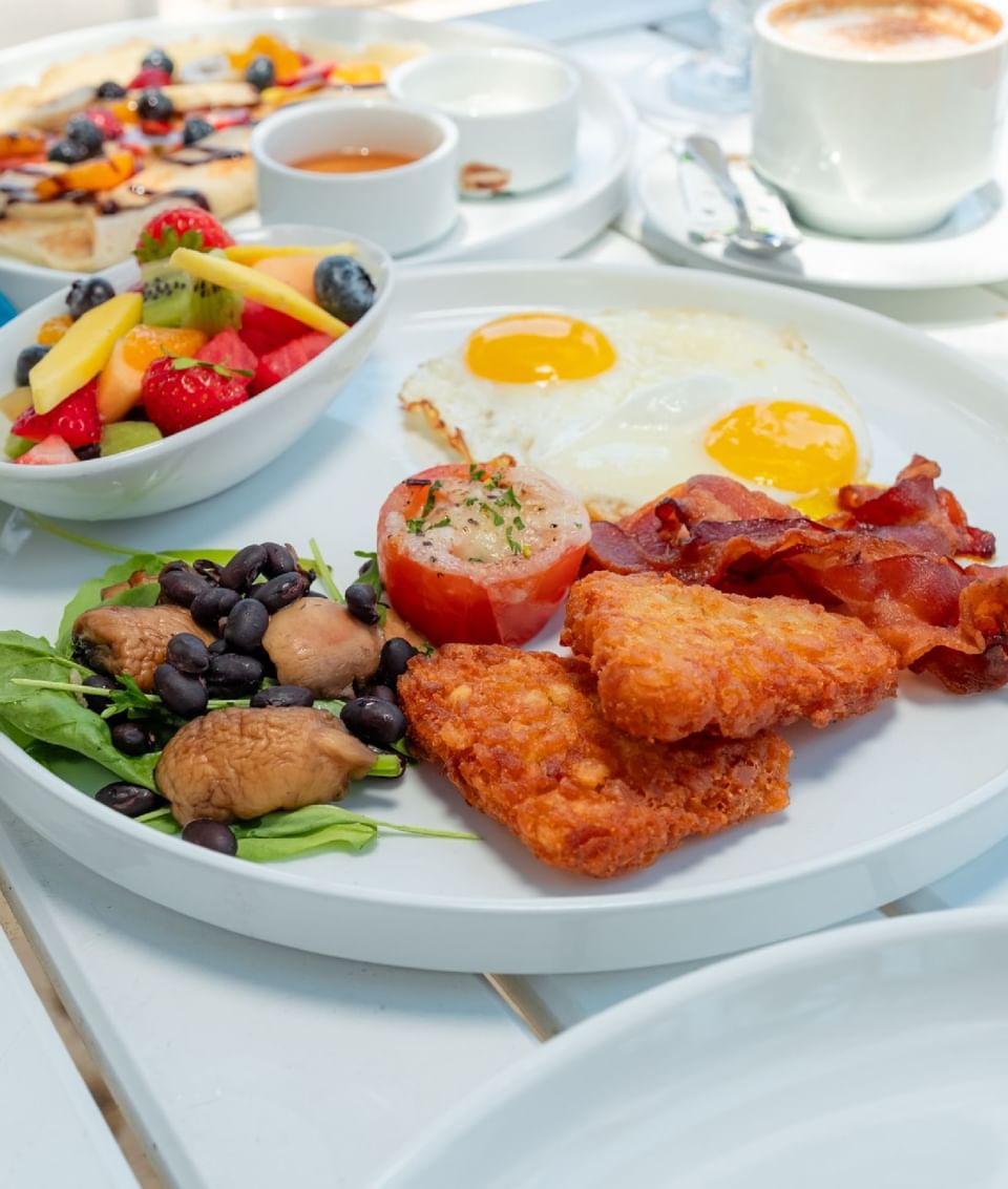 Breakfast served with coffee and fruits on the deck at Passions on the Beach