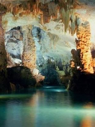 Jeita Grotto with stone pillars by a turquoise pool under soft light near Warwick Stone 55 - Beirut