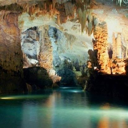 Jeita Grotto with stone pillars by a turquoise pool under soft light near Warwick Stone 55 - Beirut