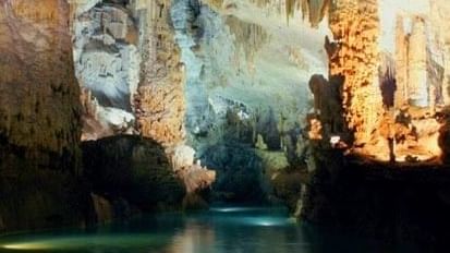 Jeita Grotto with stone pillars by a turquoise pool under soft light near Warwick Stone 55 - Beirut