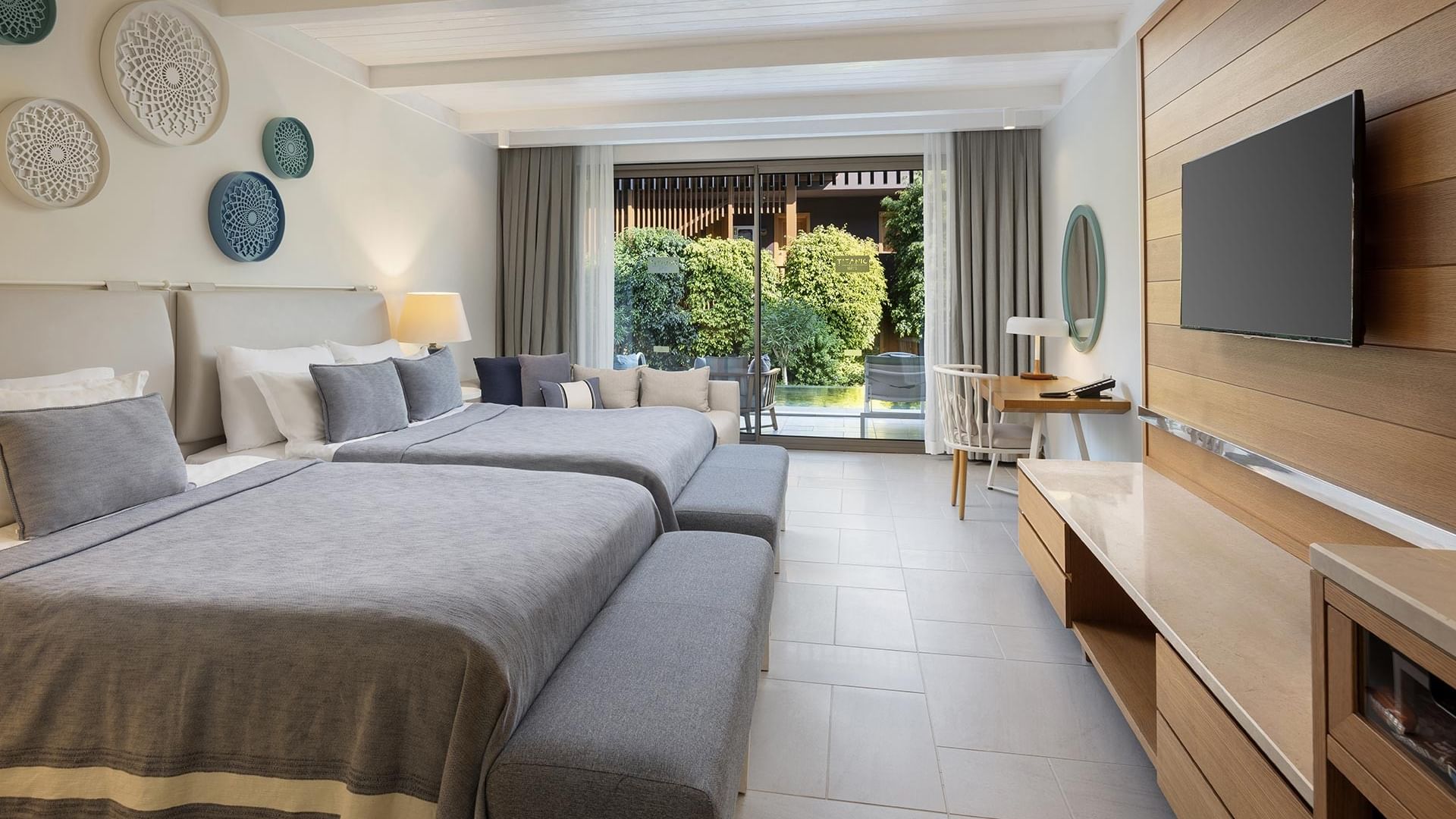 Swim-up Superior Room with twin beds, blue bedding, and a balcony overlooking pool at Titanic Luxury Collection Bodrum.