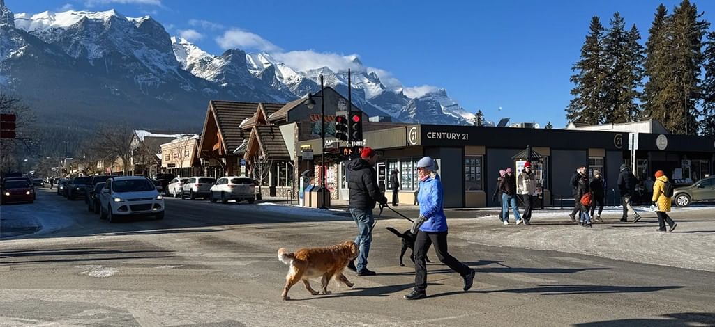 People walk around downtown Canmore on a chilly day during shoulder season.