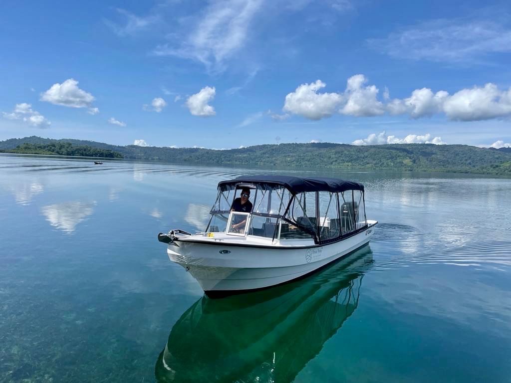 Boat with a canopy floating on a lake near Central Hotel Bocas Del Toro