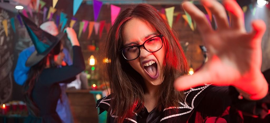 Young woman screaming playfully with her hand raised like a c