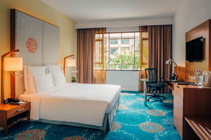 Bed, desk & TV station of Premier Room at Paradox Singapore