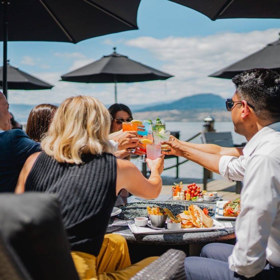 Group of friends cheersing their cocktails.
