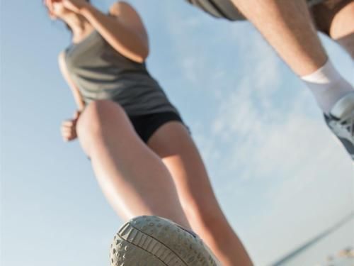 Closeup on a couple who runs in the park near Grand Coloane