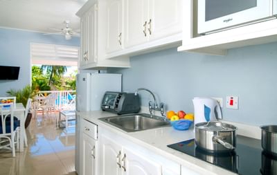 Kitchen and balcony area in One Bedroom Garden Pool View at Dover Beach Hotel