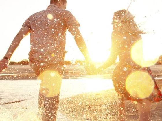 Couple holding hands on the beach