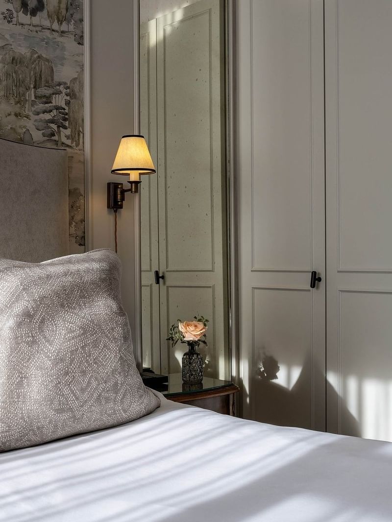 Close-up of bed near the wood cabinet in Standard Room at The Capital Hotel, Apartments & Townhouse