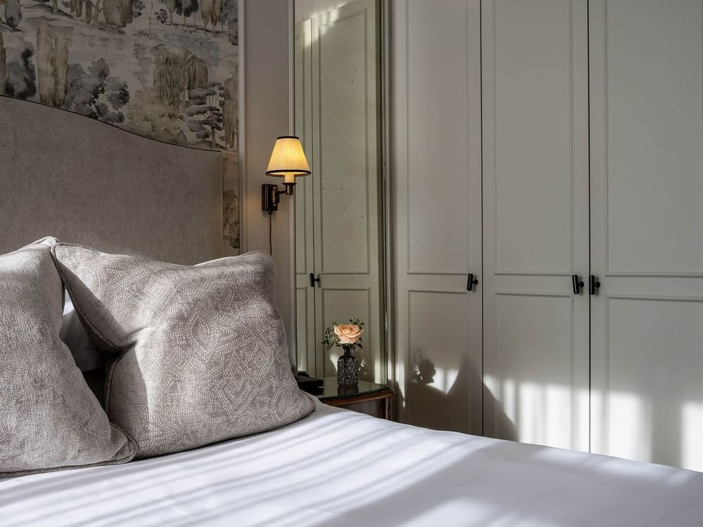 Close-up of bed near the wood cabinet in Standard Room at The Capital Hotel, Apartments & Townhouse