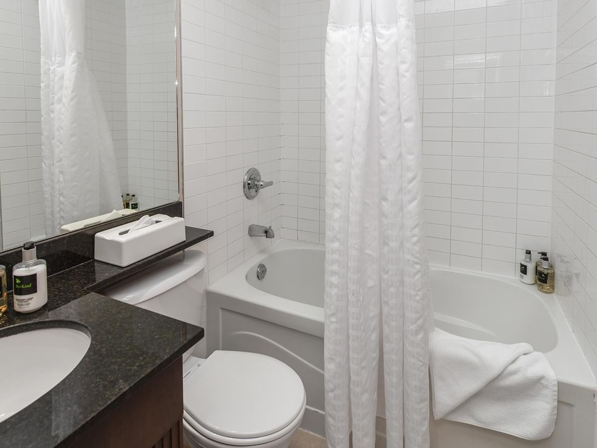 Bathroom with bathtub, toilet, and sink.